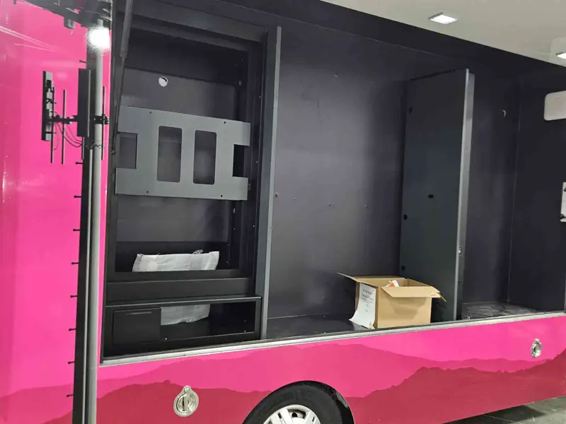 Side compartment of a mobile retail van with a display mount bracket fitted