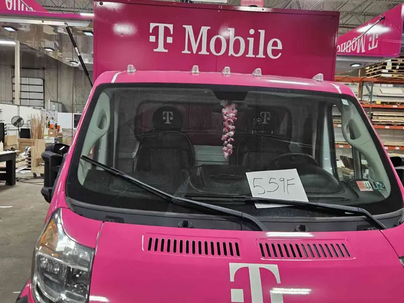 Front of a branded mobile retail van in a fabrication shop