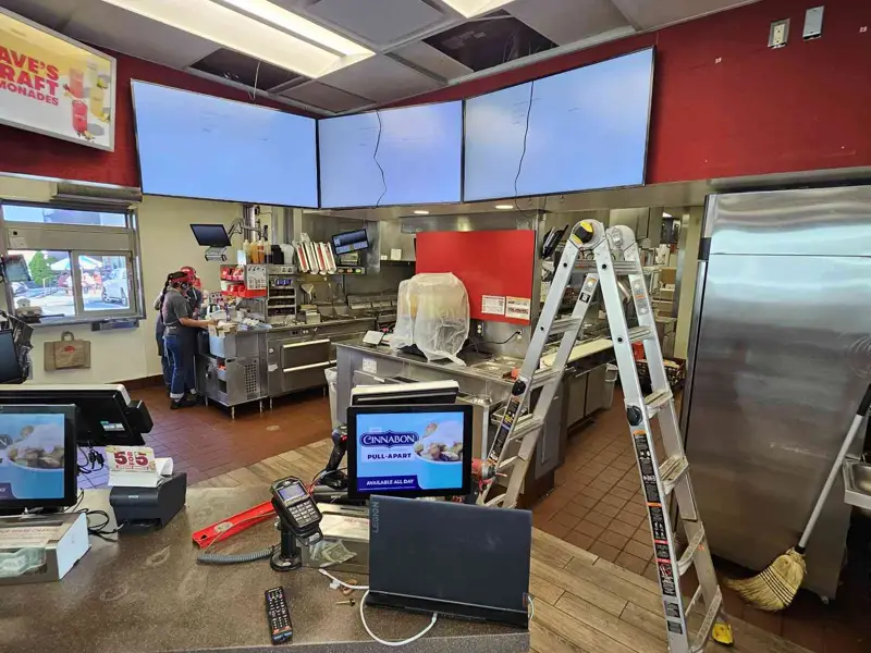 Wide view of the overhead screen array and front counter during install