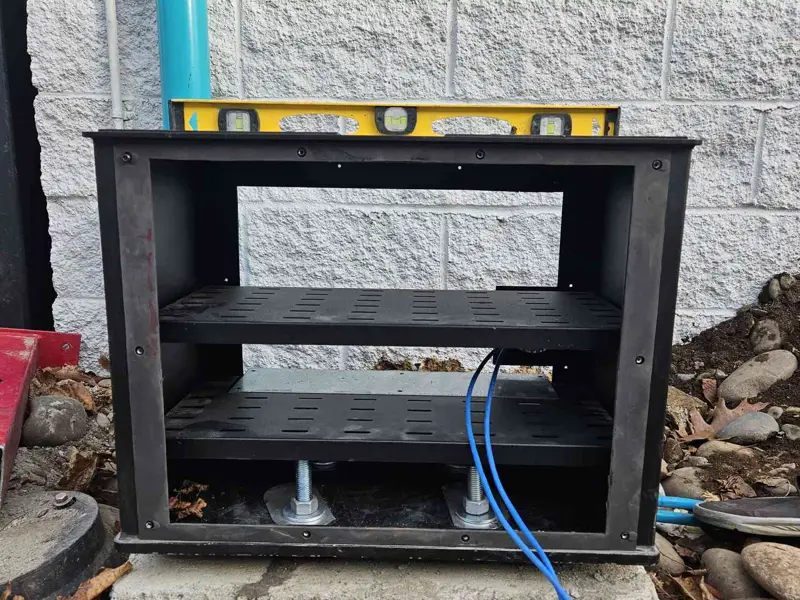 Order pedestal frame on a concrete pad with a spirit level across the top